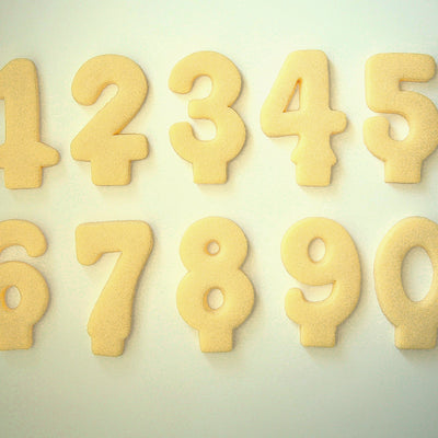 Set of number-shaped cookie candles from 1-9 on a light background