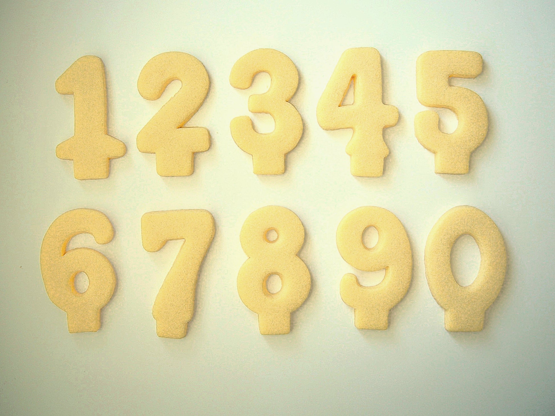 Set of number-shaped cookie candles from 1-9 on a light background
