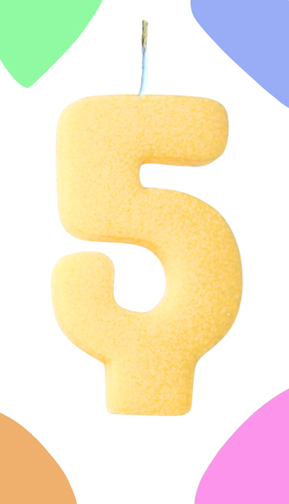 Yellow number 5 candle against a colorful background