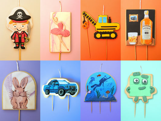 Collection of colorful children's edible cookie candles with various designs on a gradient background