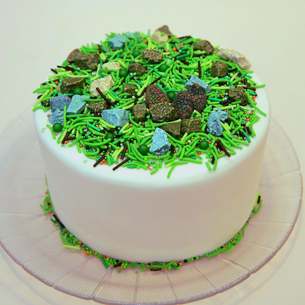 White cake with green sprinkles on a white cake 