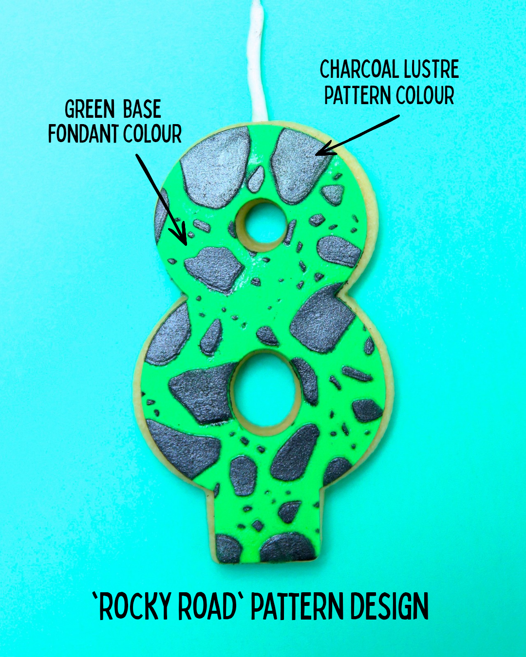 Green edible number eight birthday candle with rocky road pattern on a blue background