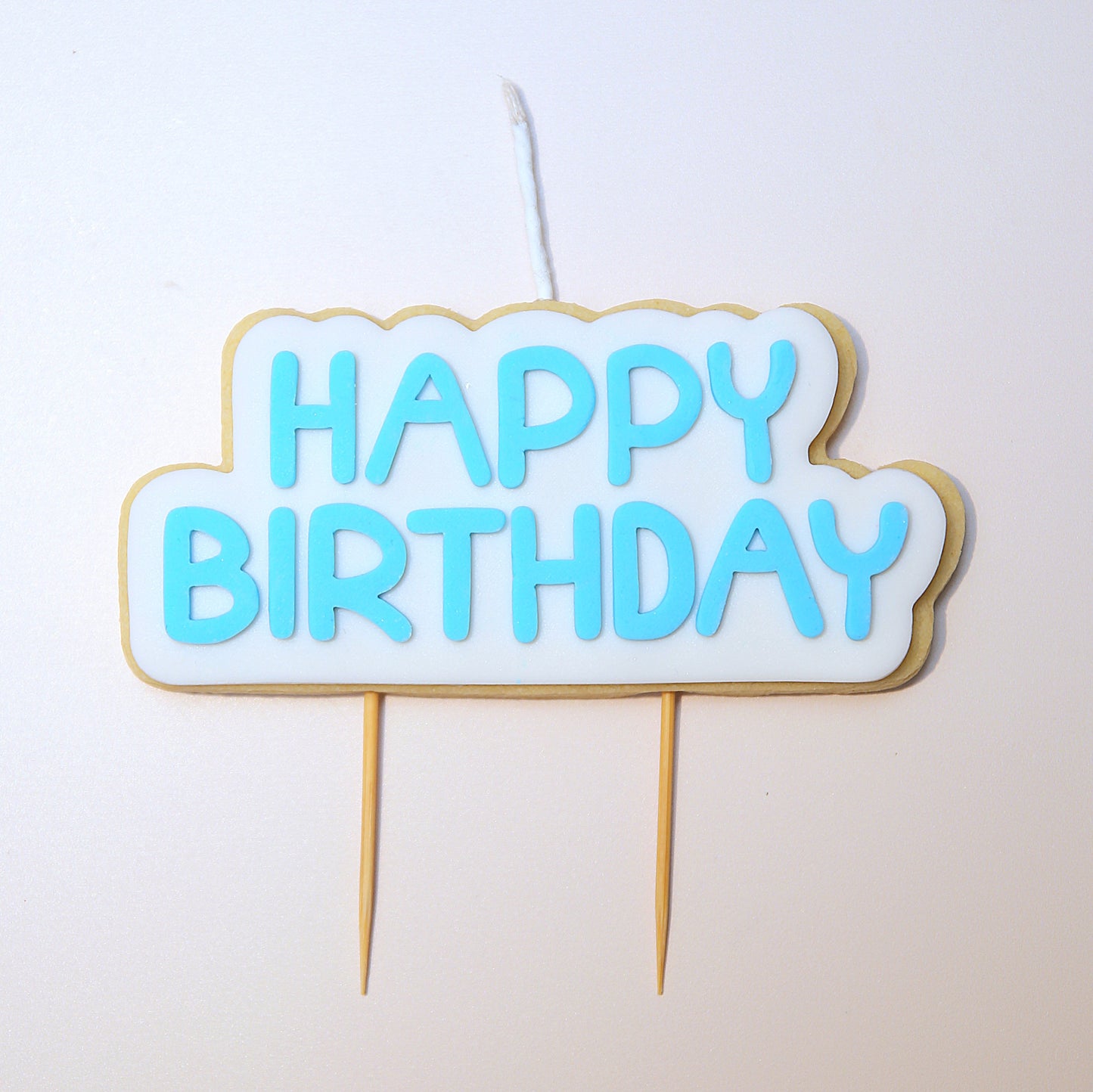 Happy Birthday Cookie Candle cake topper with blue text on a white background