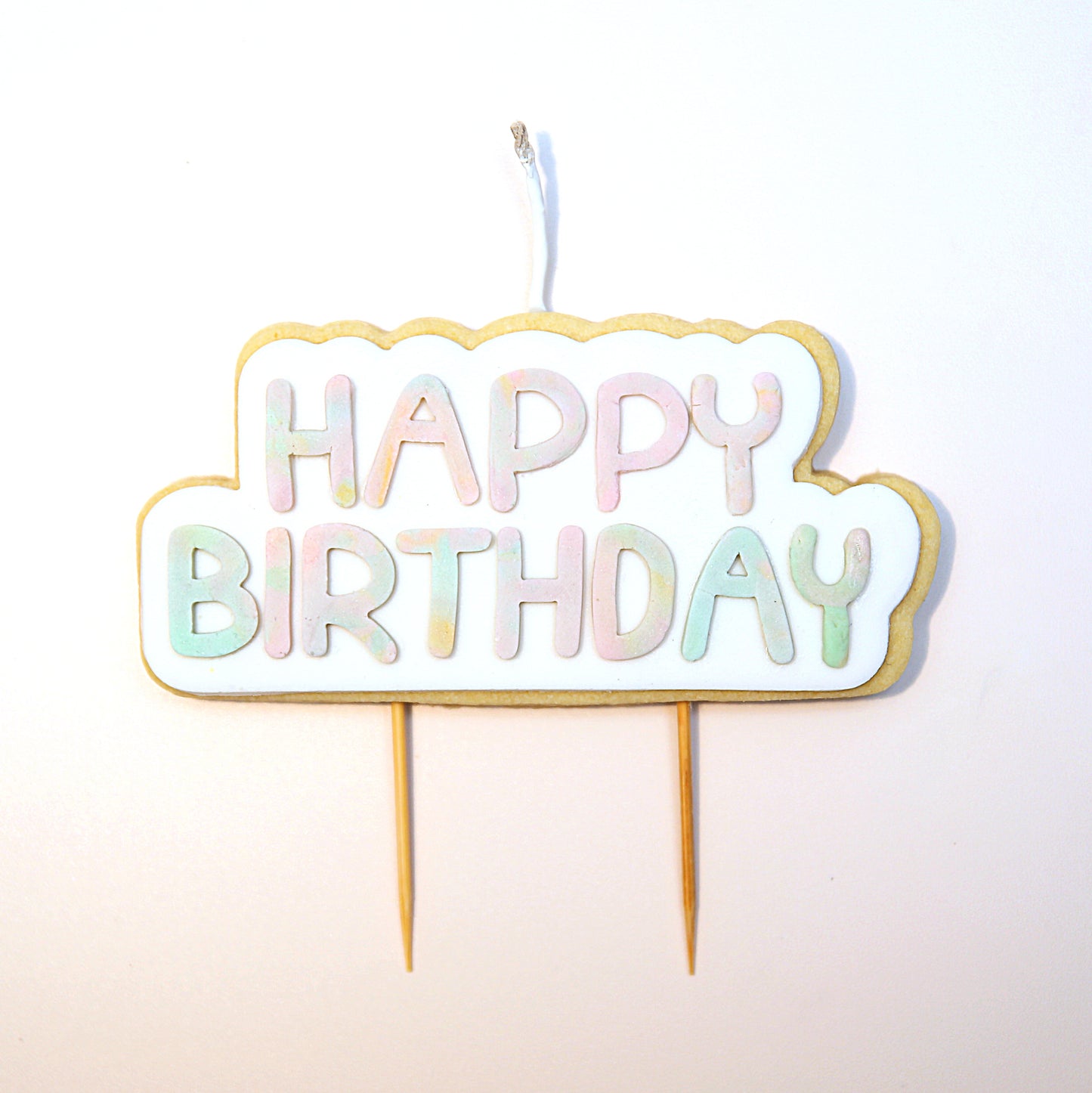 Multicoloured 'Happy Birthday' Cookie Candle on a white background