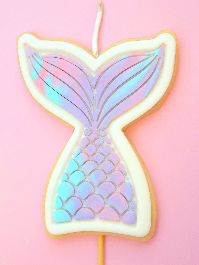Mermaid tail themed Cookie Candle decorated with a marbled teal purple and pink effect.