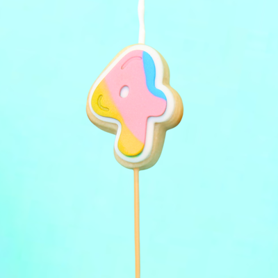 Colorful number 4 cookie on a stick against a light blue background