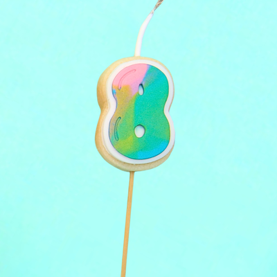 Colorful birthday candle shaped like a number '8' on a blue background