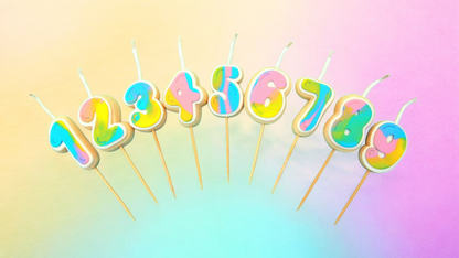 Set of tiny colourful number candles from 1-9 on a rainbow gradient background 