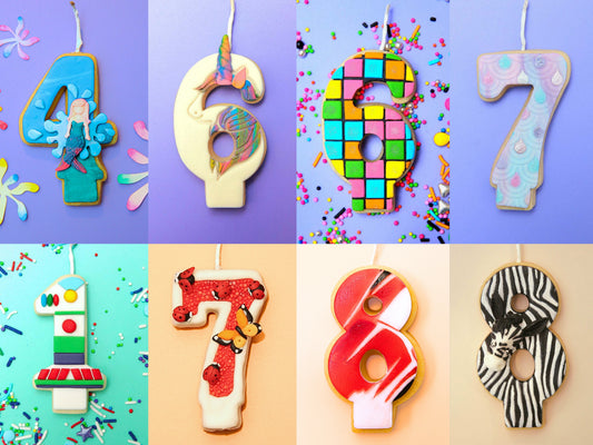 A variety of colourful number-shaped edible Cookie Candles on a purple background with confetti.