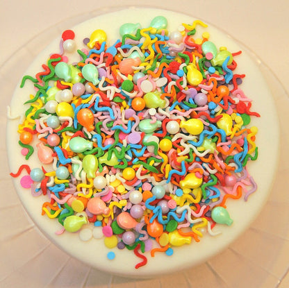 Colorful birthday balloon sprinkle mix on a white cake