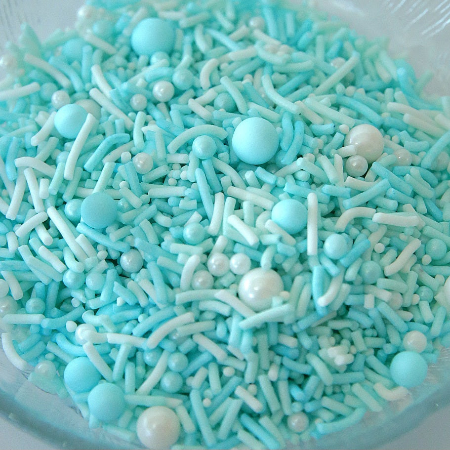 Pastel blue and white edble decorative sprinkles in a bowl