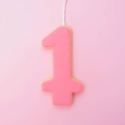 Pink number '1' cookie on a pink background