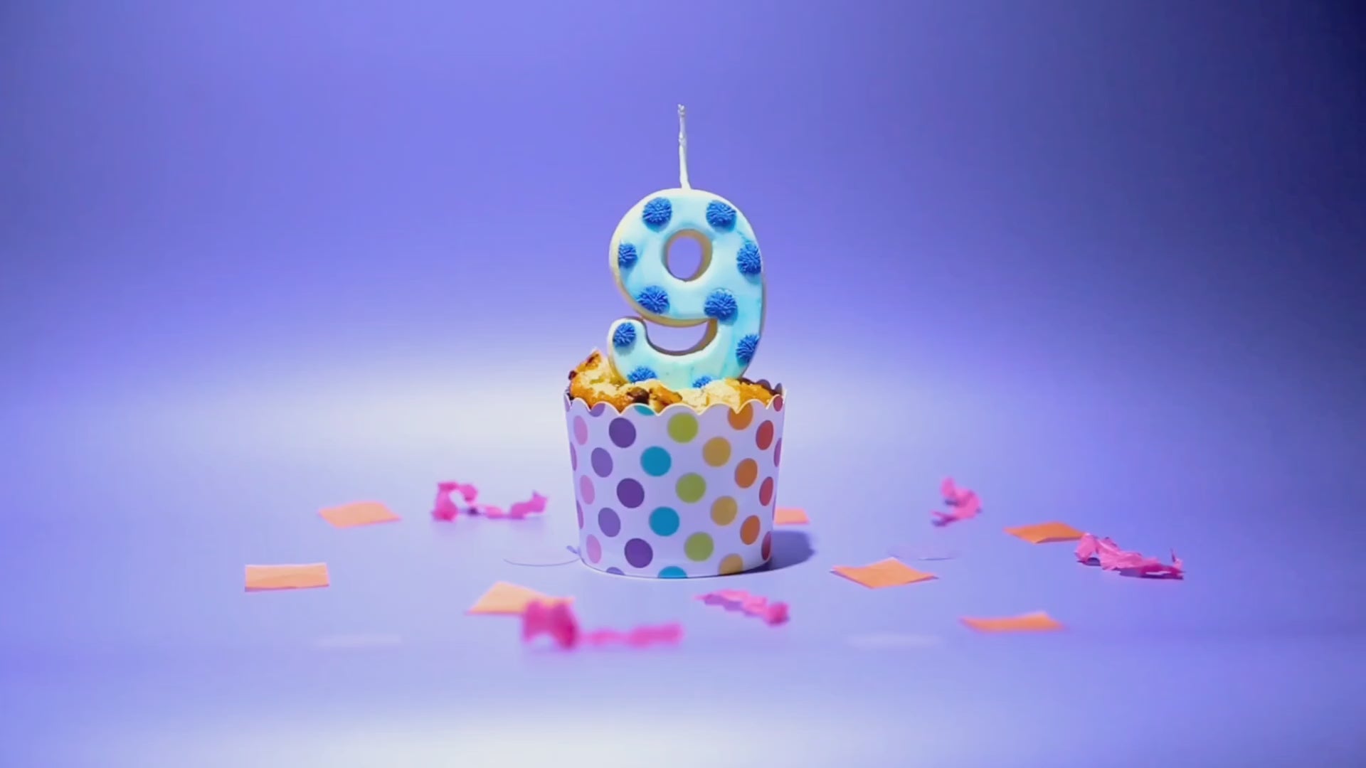 Load video: A blue number '9' Cookie Candle being lit and the blown out.
